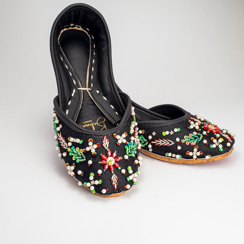 Side view of Bahar Khussa with pearls and beads on black raw silk by Behnaz Pakistan