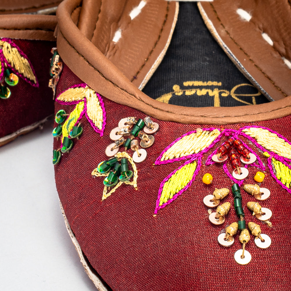 Top view highlighting the multicolored Zari patterns on bronze raw silk of Shaista chappal by Behnaz Pakistan