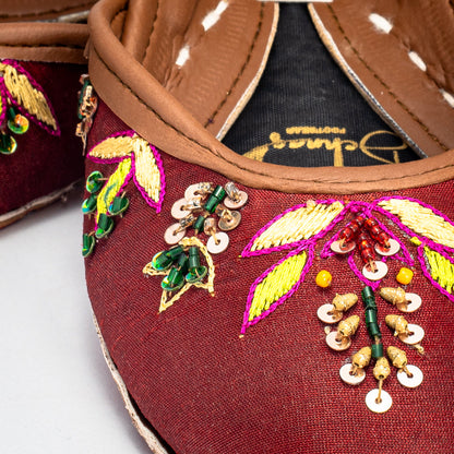 Top view highlighting the multicolored Zari patterns on bronze raw silk of Shaista chappal by Behnaz Pakistan